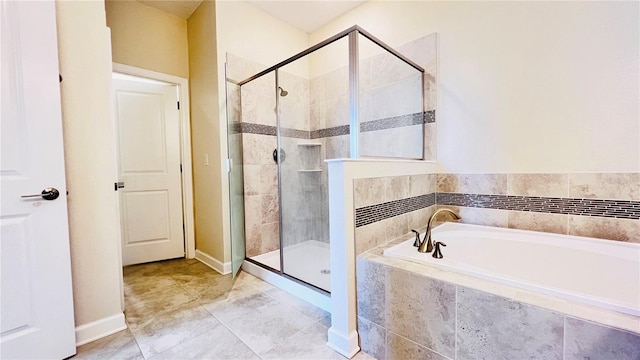 bathroom with tile patterned flooring and independent shower and bath