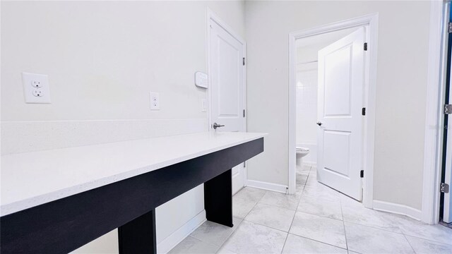 bathroom with tile patterned floors and toilet