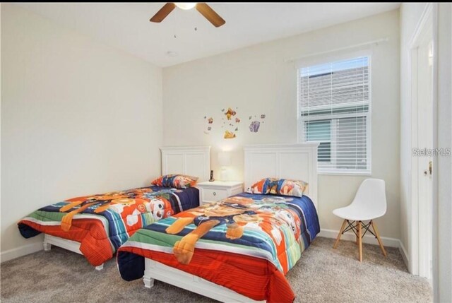 bedroom featuring light colored carpet and ceiling fan