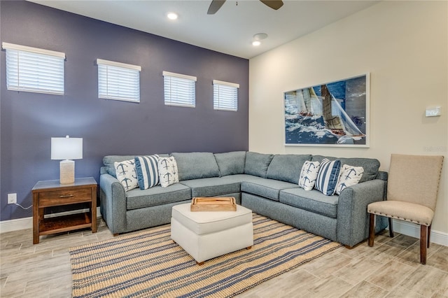 living room featuring plenty of natural light and ceiling fan