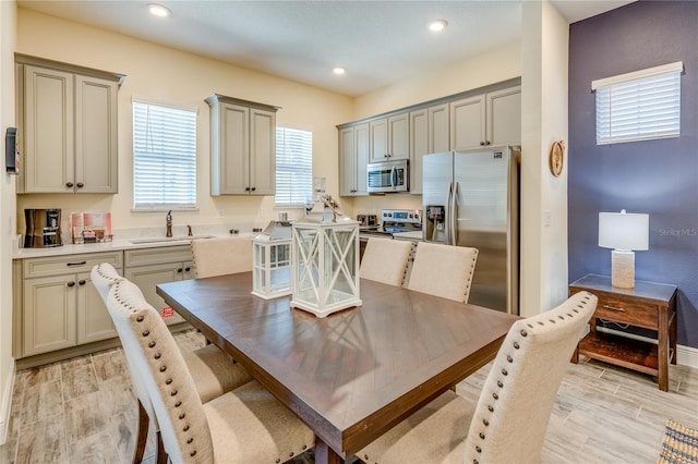 dining room featuring sink and light hardwood / wood-style floors