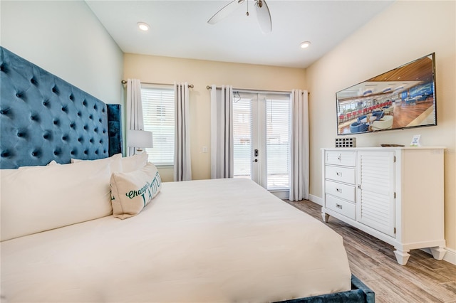 bedroom featuring access to exterior, french doors, light hardwood / wood-style floors, and ceiling fan