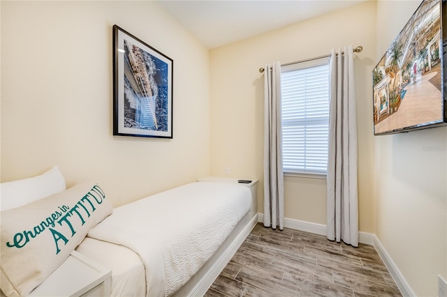 bedroom with hardwood / wood-style flooring