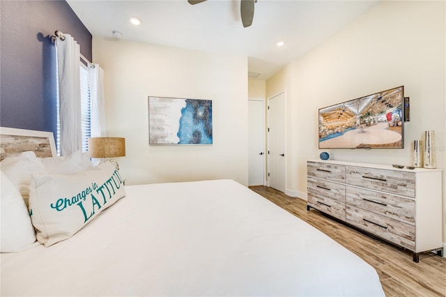 bedroom with hardwood / wood-style flooring and ceiling fan