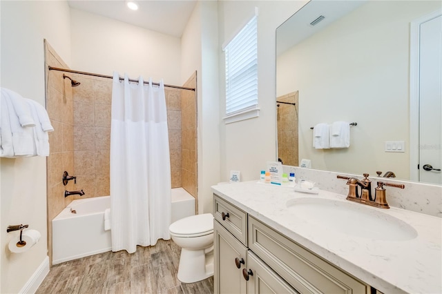 full bathroom with hardwood / wood-style floors, vanity, toilet, and shower / bath combo