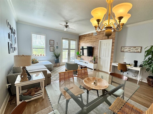 living room with crown molding, wooden walls, and a textured ceiling