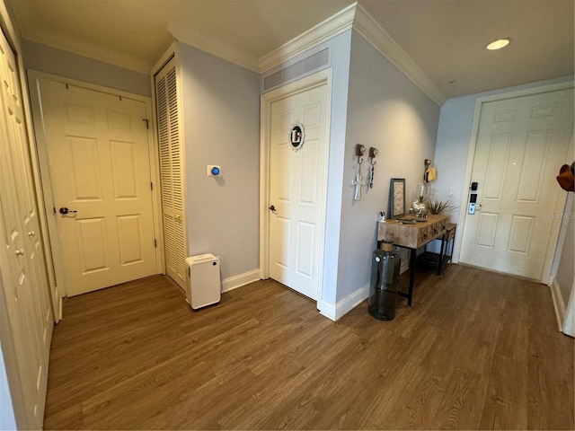 corridor with dark wood-type flooring and crown molding