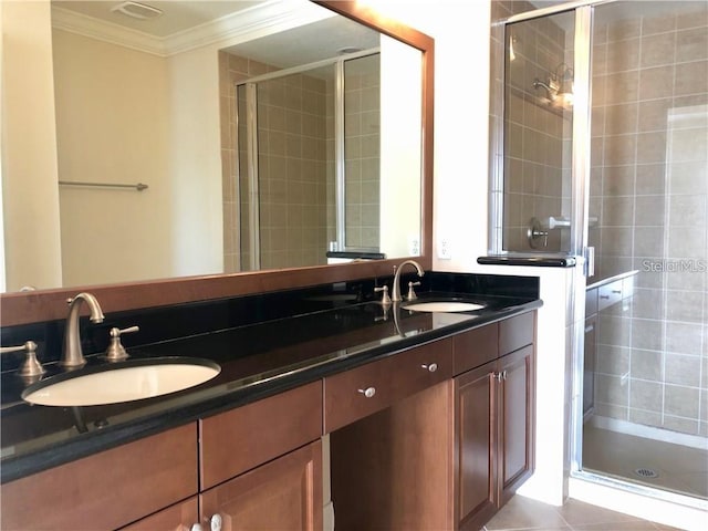 bathroom featuring an enclosed shower, vanity, tile patterned floors, and ornamental molding