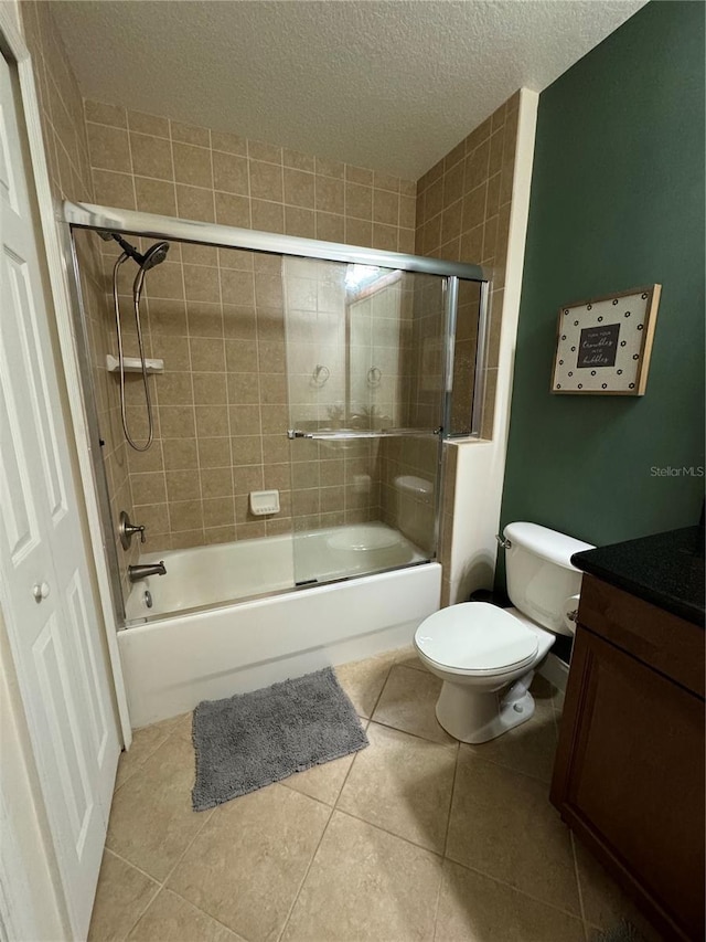 full bathroom featuring toilet, tile patterned floors, a textured ceiling, vanity, and shower / bath combination with glass door