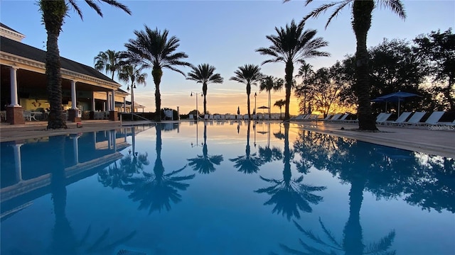 pool at dusk with a water view