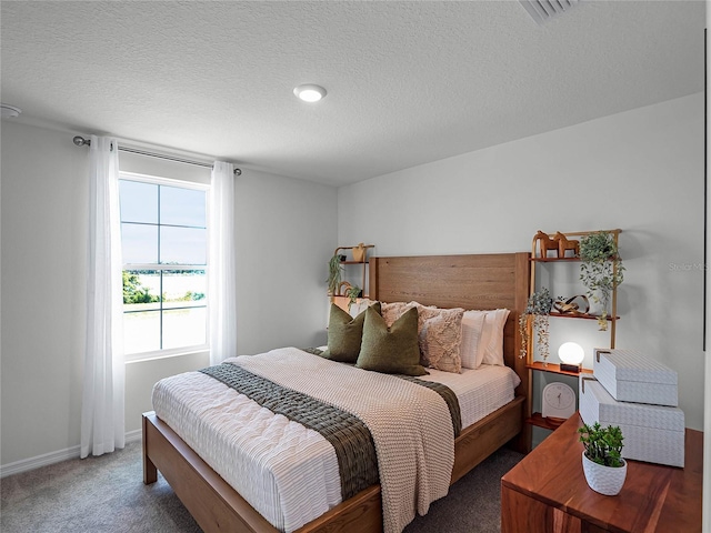 carpeted bedroom with a textured ceiling