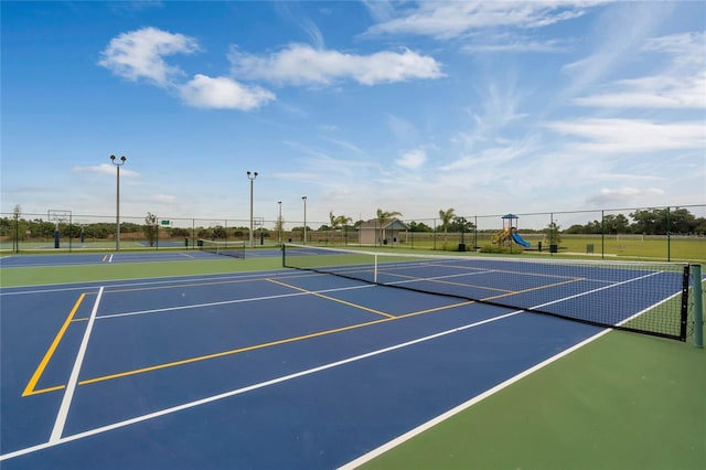 view of tennis court featuring basketball hoop