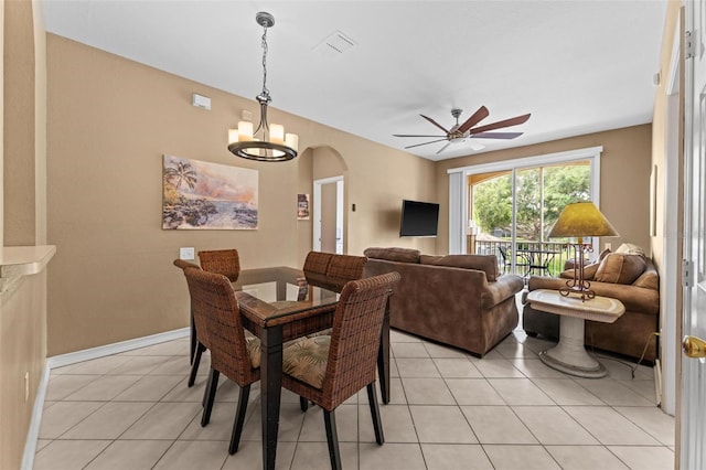 dining area featuring ceiling fan with notable chandelier and light tile patterned floors