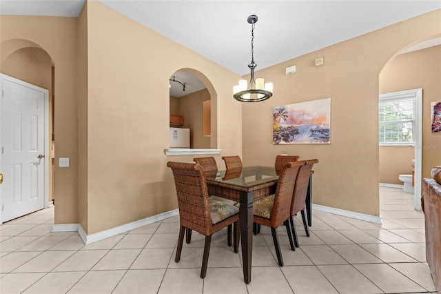 dining space with an inviting chandelier and light tile patterned flooring