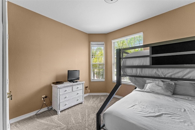 bedroom featuring light carpet