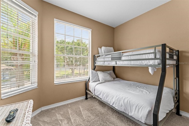 carpeted bedroom with multiple windows