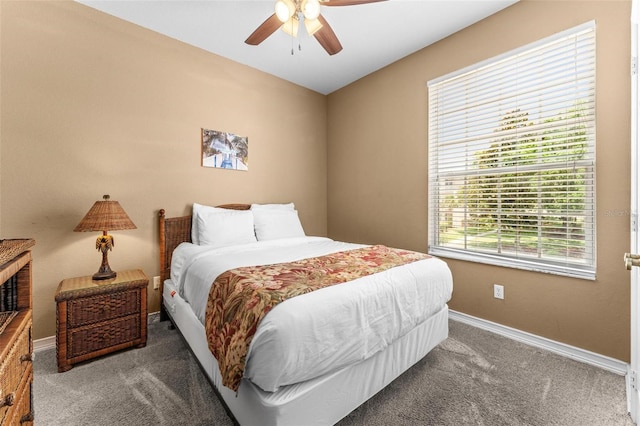 bedroom with ceiling fan and dark colored carpet