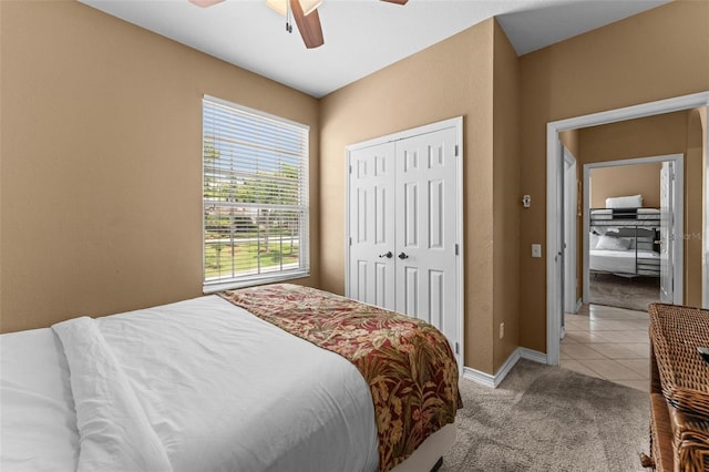 carpeted bedroom with ceiling fan and a closet