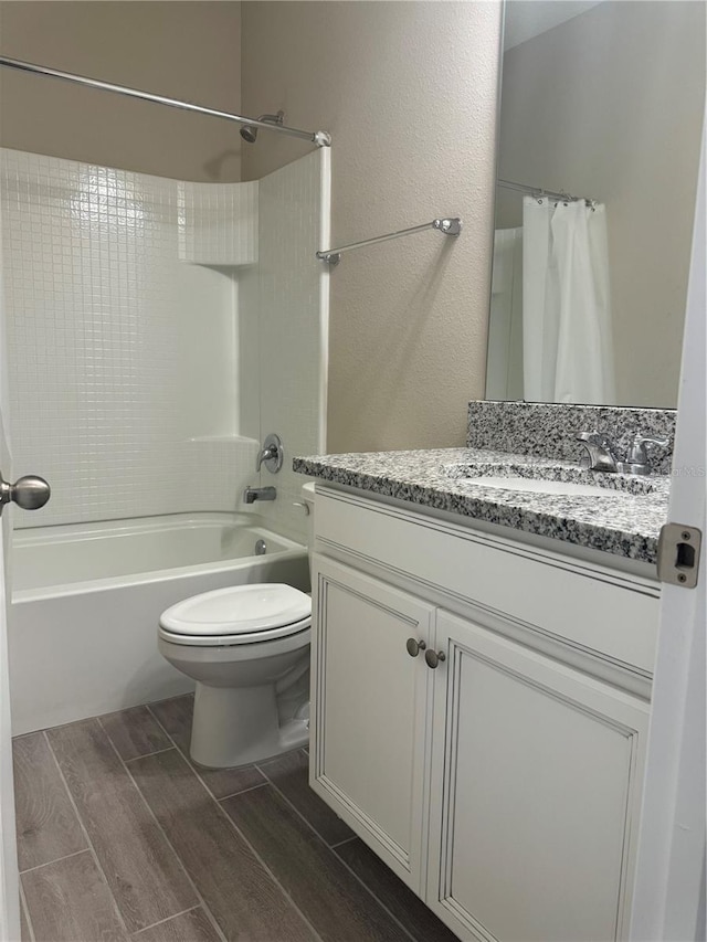 full bathroom with wood-type flooring, vanity, toilet, and shower / bathtub combination with curtain