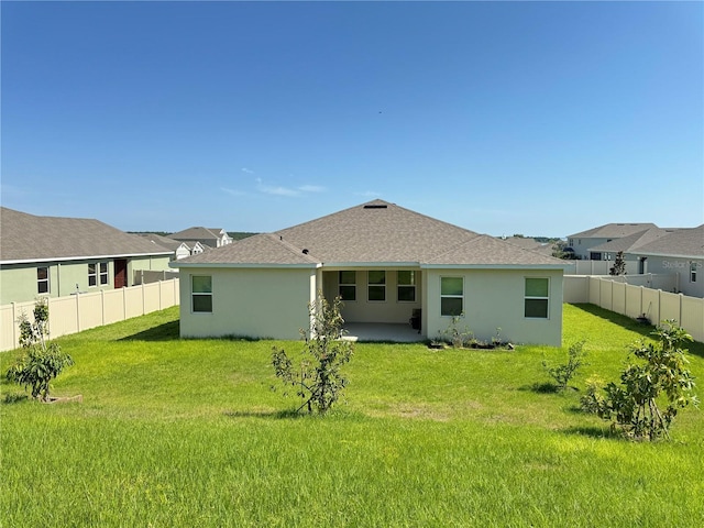 back of house featuring a yard