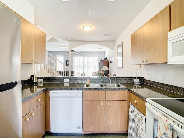 kitchen with white appliances, ceiling fan, and sink