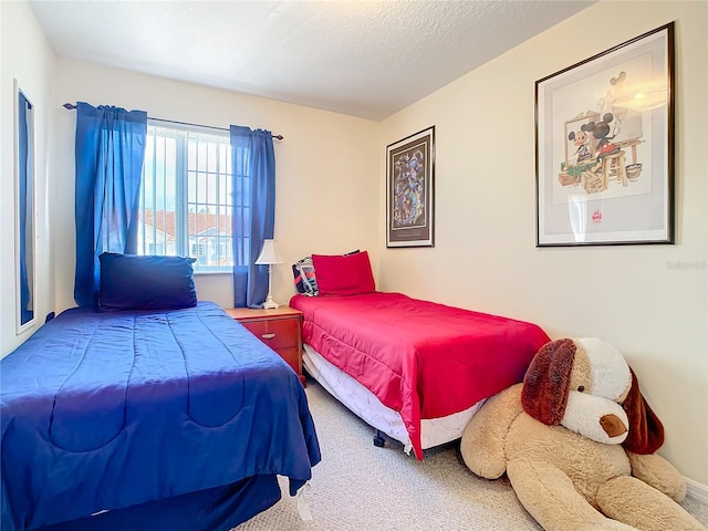 bedroom with carpet and a textured ceiling