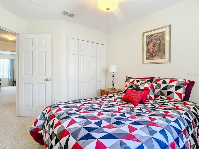 carpeted bedroom featuring a closet and ceiling fan