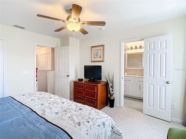 bedroom featuring ensuite bath and ceiling fan