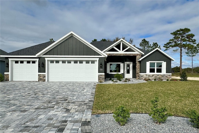 craftsman-style house with a front lawn and a garage