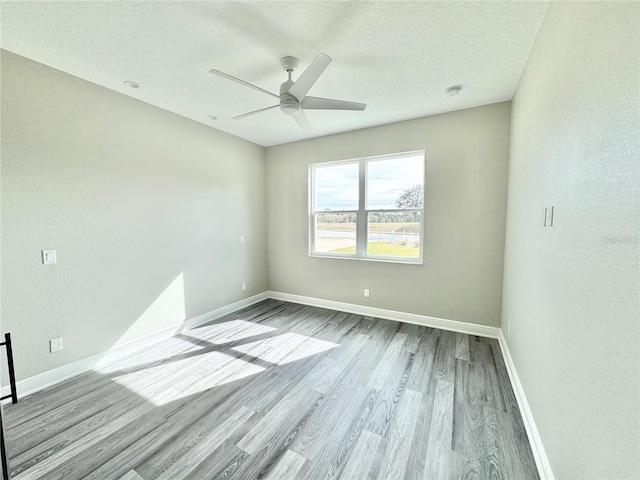 unfurnished room featuring a textured ceiling, wood-type flooring, and ceiling fan