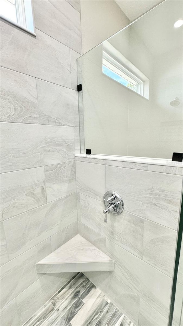 bathroom with tiled shower