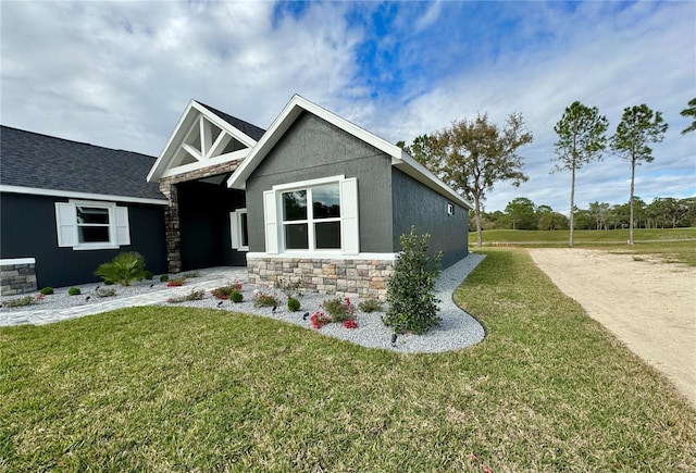 craftsman-style home with a front lawn