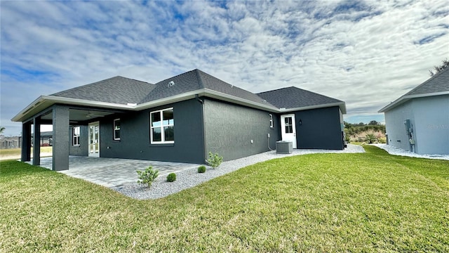 back of house featuring a patio and a lawn