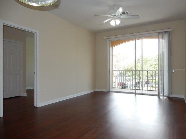 spare room with ceiling fan and dark wood-type flooring