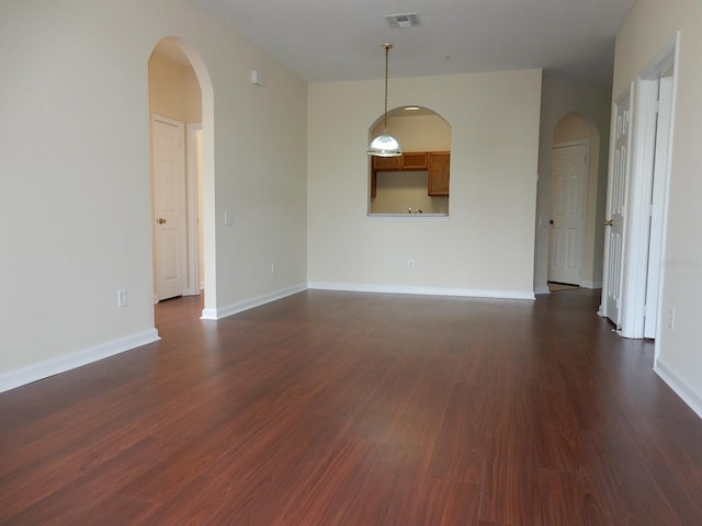 unfurnished room featuring dark wood-type flooring