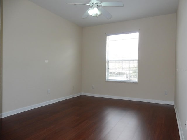 spare room featuring ceiling fan and dark hardwood / wood-style flooring