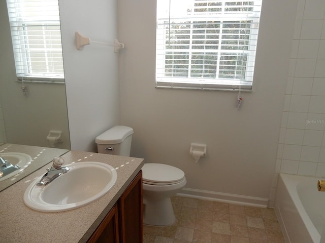 full bathroom with a wealth of natural light, vanity, tub / shower combination, and toilet