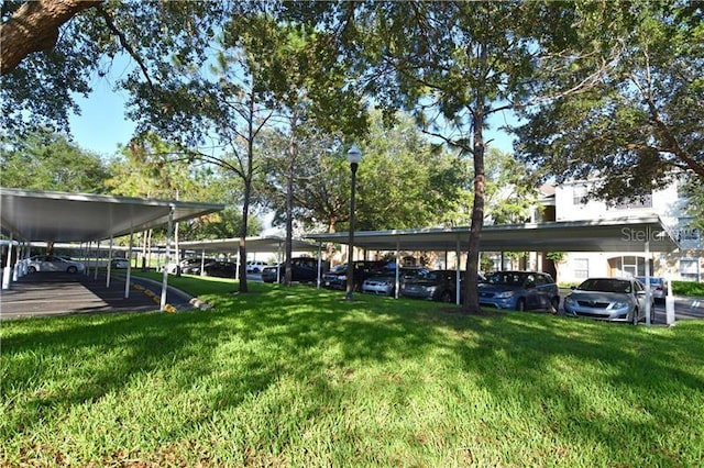 view of vehicle parking featuring a lawn