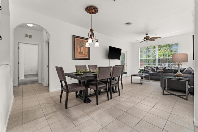 tiled dining space featuring ceiling fan