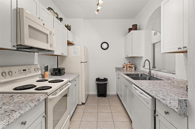 kitchen featuring sink, white cabinets, white appliances, and light tile floors