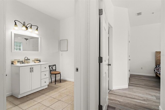 bathroom with hardwood / wood-style flooring and vanity