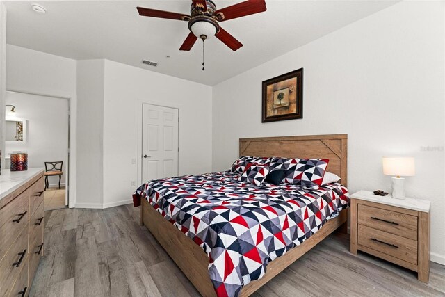 bedroom featuring ceiling fan and light hardwood / wood-style flooring