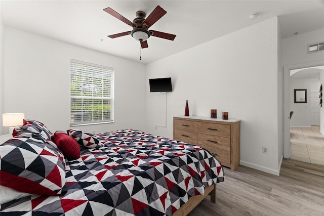 bedroom with ceiling fan and light wood-type flooring