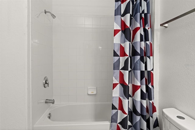 bathroom with shower / bathtub combination with curtain and toilet