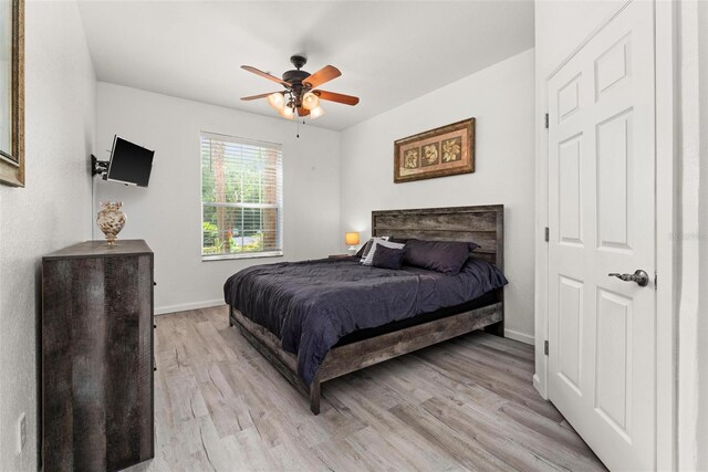 bedroom with ceiling fan and light hardwood / wood-style flooring