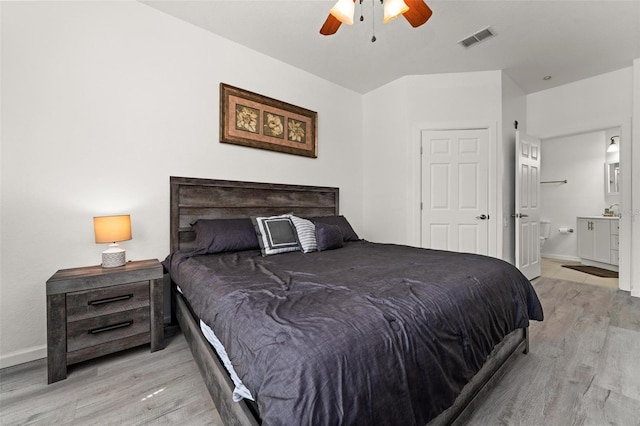 bedroom with wood-type flooring, ensuite bathroom, and ceiling fan