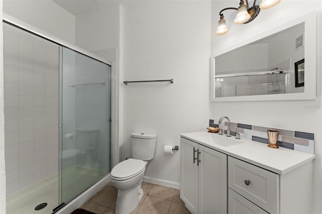 bathroom featuring tasteful backsplash, a shower with door, tile floors, toilet, and vanity