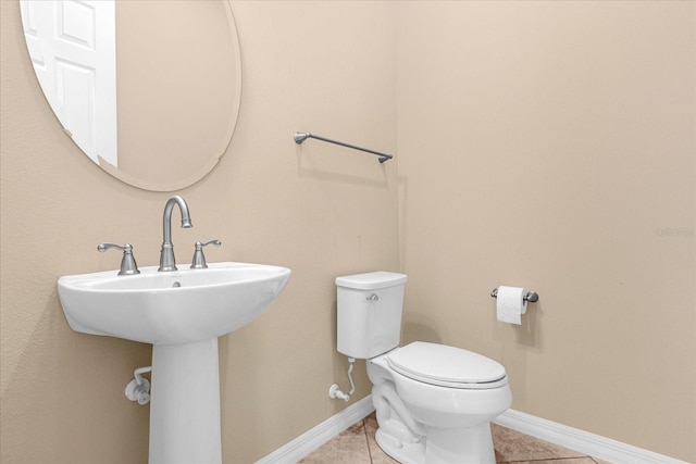 bathroom with tile patterned floors, toilet, and sink