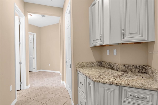 kitchen with light stone countertops and light tile patterned floors