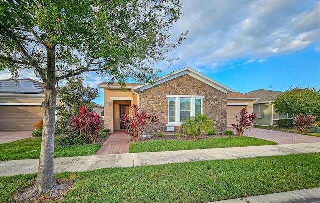 view of front of house with a garage and a front lawn